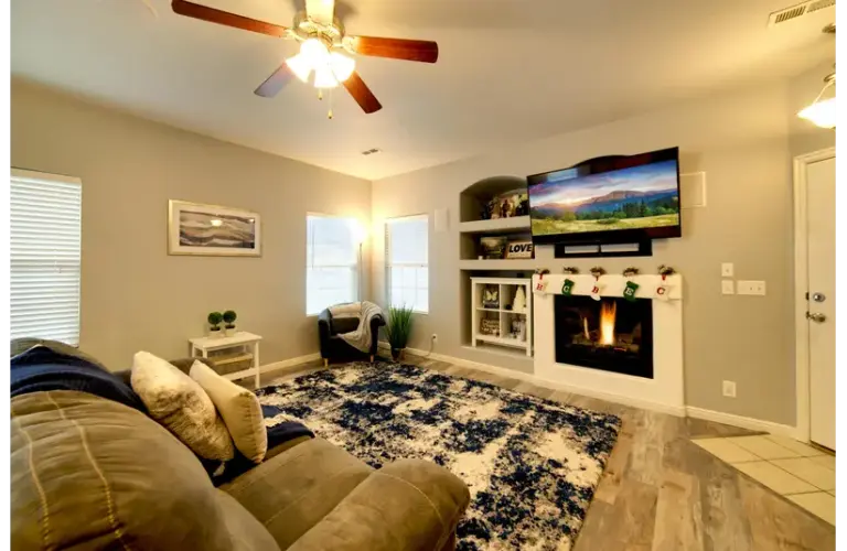 a beautiful living area with a simple and decent mantel decor