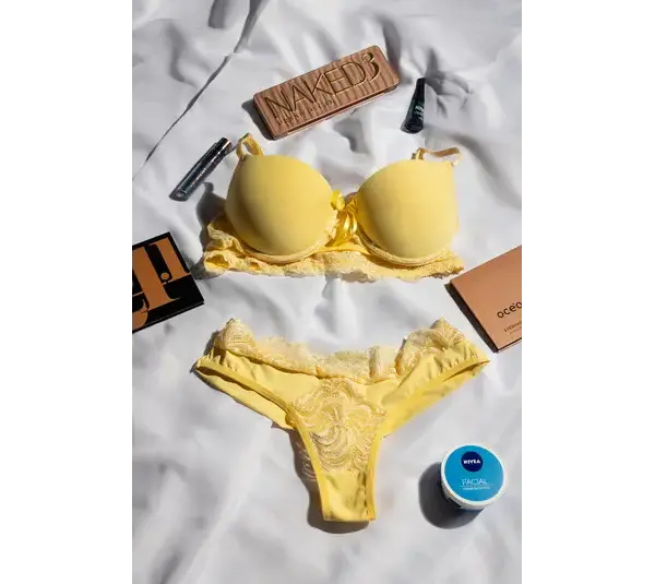 a yellow color lingerie with some makeup products