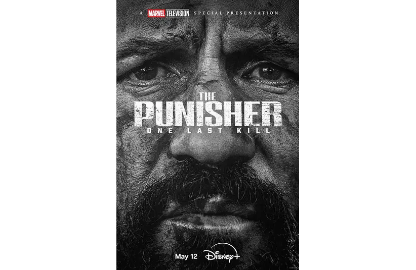 Poster for "The Punisher: One Last Kill" featuring a close-up, intense, black-and-white portrait of a man's face. Text includes "May 12" and "Disney+."