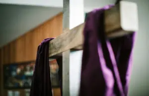Image of a white wooden cross with purple fabric draped over it, Easter, Lent, Laetare Sunday