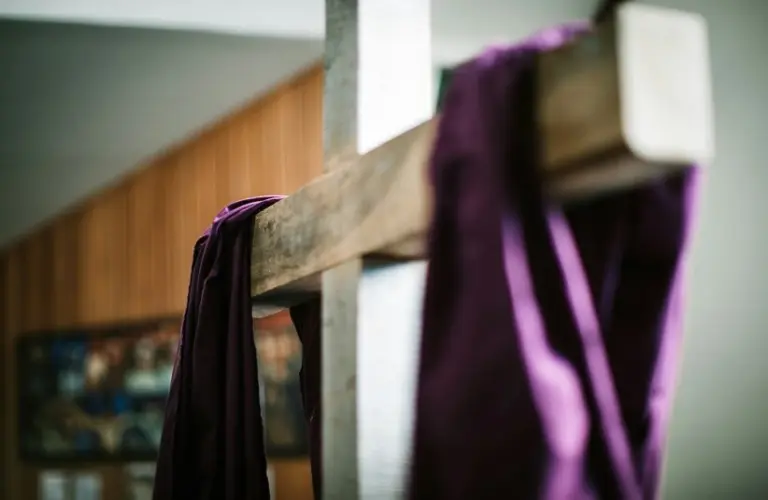 Image of a white wooden cross with purple fabric draped over it, Easter, Lent, Laetare Sunday