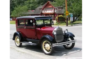 A red 1928 Model A Ford in front of Bowen Island Public Library, owned by Dan C. of Bowen Island.