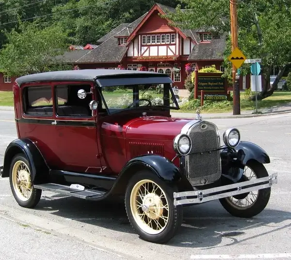 A red 1928 Model A Ford in front of Bowen Island Public Library, owned by Dan C. of Bowen Island.