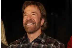 Image of Chuck Norris smiling in a plaid button down.