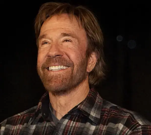 Image of Chuck Norris smiling in a plaid button down.