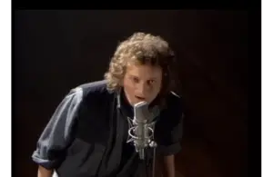 Screenshot of Lou Gramm singing in Foreigner video “I Want to Know What Love Is”