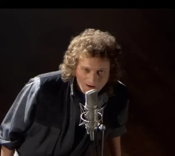 Screenshot of Lou Gramm singing in Foreigner video “I Want to Know What Love Is”