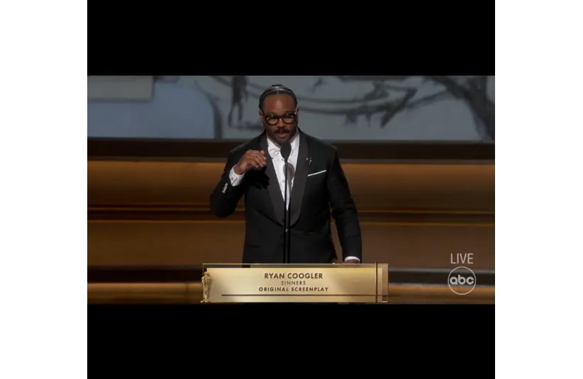 Image of Ryan Coogler receiving Oscar for Best Original Screenplay for Sinners