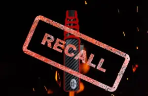 Image of Royal Oak Flame Saber Lighter on a black background with flames and the word Recall stamped over it