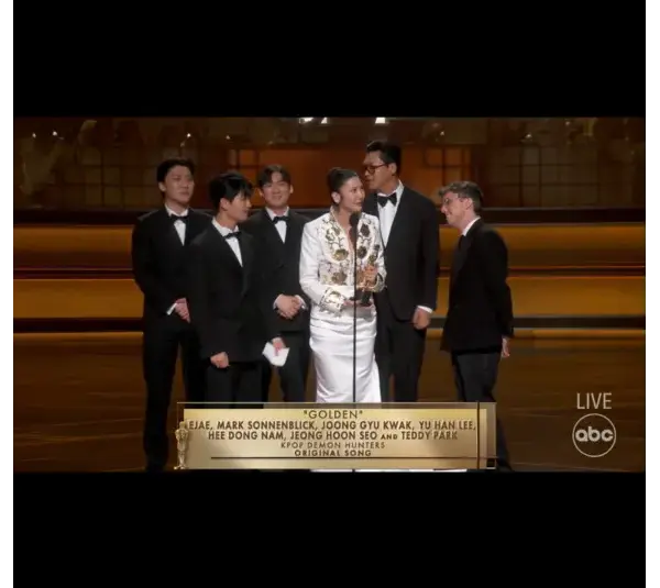 Image of Ejae, Mark Sonnenblick, Joong Gyu Kwak, Yu Han Lee, Hee Dong Nam, Jeong Hoon Seo, and Teddy Park accepting the Oscar for Best Original Song, Golden, KPop Demon Hunters