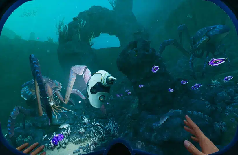 View from an underwater helmet showing a vibrant blue seascape with large crab-like creatures, purple fish, corals, and rock formations; hands in foreground convey exploration.