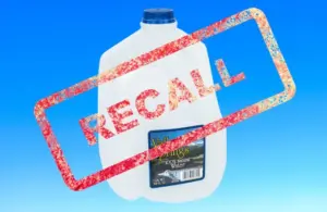 Image of gallon bottle of Valley Springs water on a light blue background with Recall stamped over it