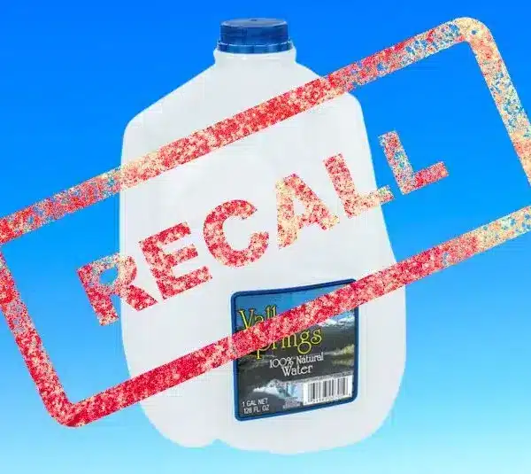 Image of gallon bottle of Valley Springs water on a light blue background with Recall stamped over it