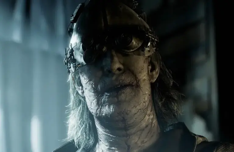 Vicotr Gideon in a dark room with large curtained windows behind him in Resident Evil Requiem