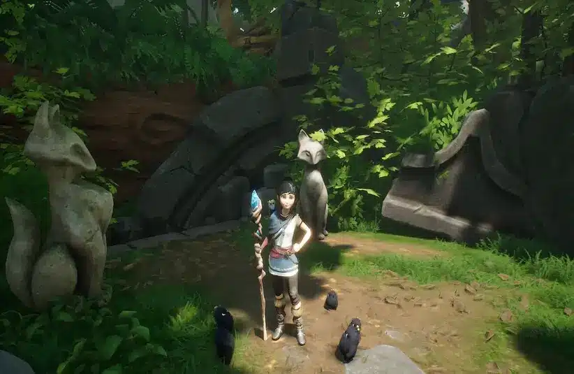 Kena poses in front of a statue in Kena: Bridge of Spirits