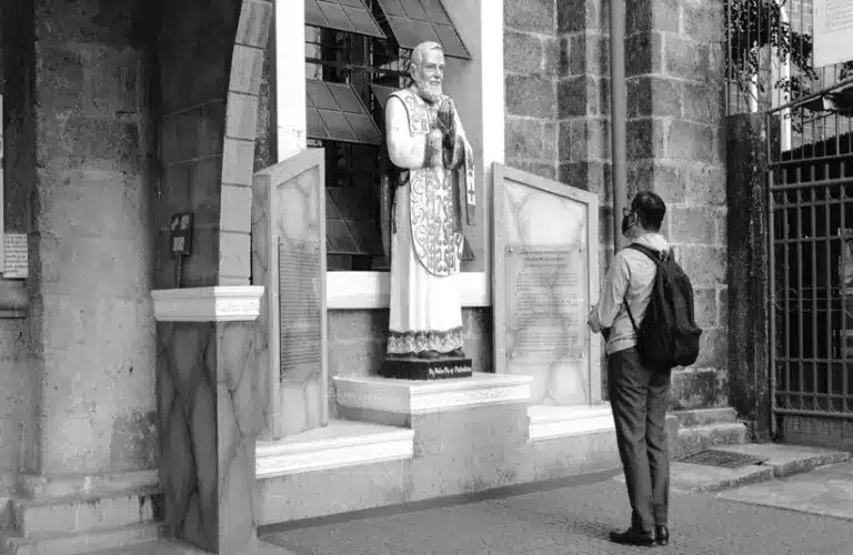 Image of a person praying at Padre Pio shrine, Diocesan Shrine and Parish of Our Lady of Light, Bonifacio Avenue, Cainta, Rizal, Philippines