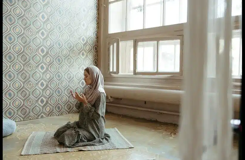 In daily devotion, a young woman prays.