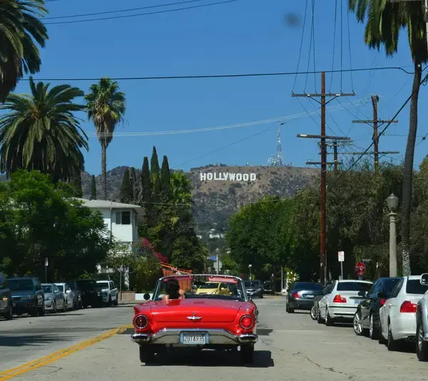 In today's daily Drop, the Hollywood sign is in the background with a red convertible driving towards it