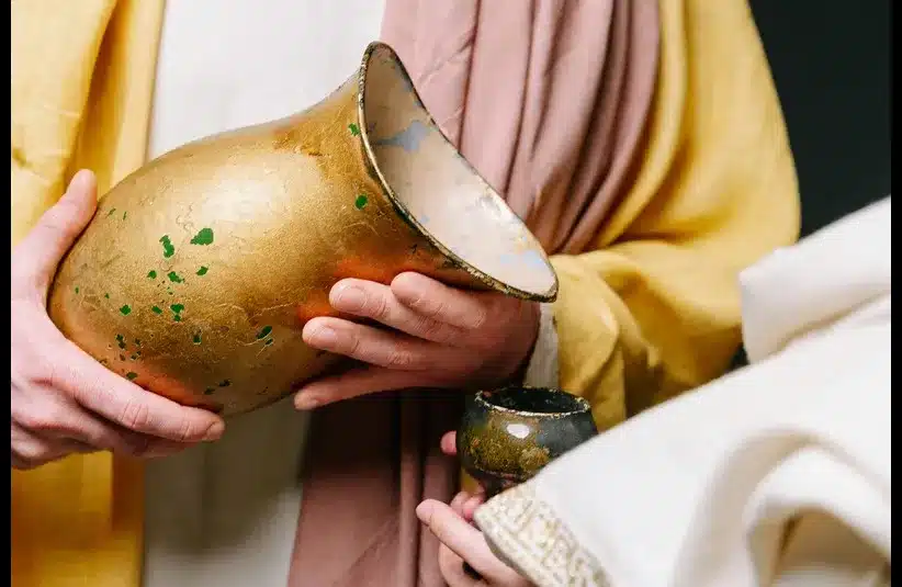 In daily devotion, a man pours from a pitcher.