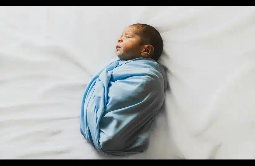 In daily devotion, a baby wrapped in a blue cloth is shown.