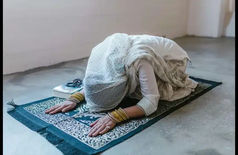 In daily devotion, a woman prays.