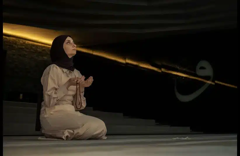 In daily devotion, a woman prays.