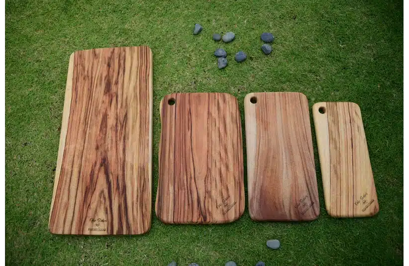 An assortment of wooden cutting boards and charcuterie boards