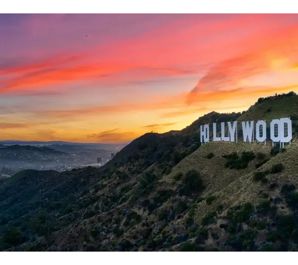 View of the Hollywood Sign with a beautiful sunset in the background. Ready to drop all the celebrity and pop culture news