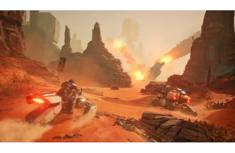 Futuristic bikes speed through a rugged desert canyon under a hazy sky in Dune: Awakening. Bright explosions illuminate the rocky terrain, adding a sense of urgency.