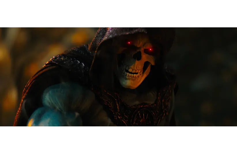Jared Leto in Masters of the Universe (2026) as Skeletor with glowing red eyes and a skeletal face, wearing dark, ornate armor. The scene is eerie and intense, set against a blurred background.