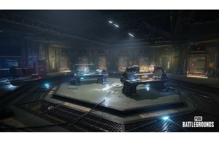 Dimly lit futuristic lab in PUBG: Battlegrounds Xeno Point, with circular layout, machinery, and glowing control panels. A mysterious, high-tech atmosphere prevails. PUBG Battlegrounds logo in the corner.