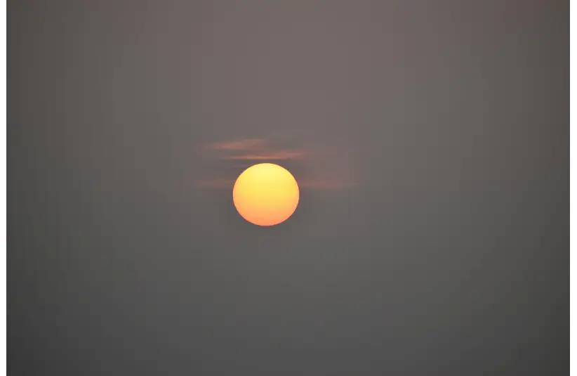 In daily devotion, the sun shines in the midst of a gray sky.
