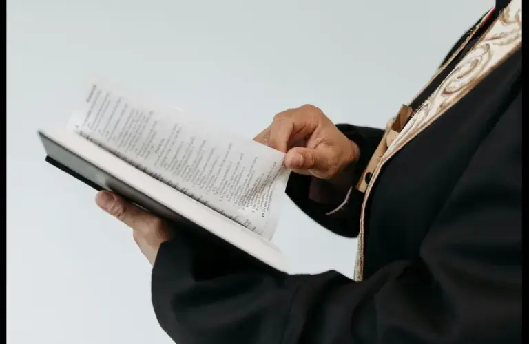 In daily devotional, a church officiant reads from the Bible.