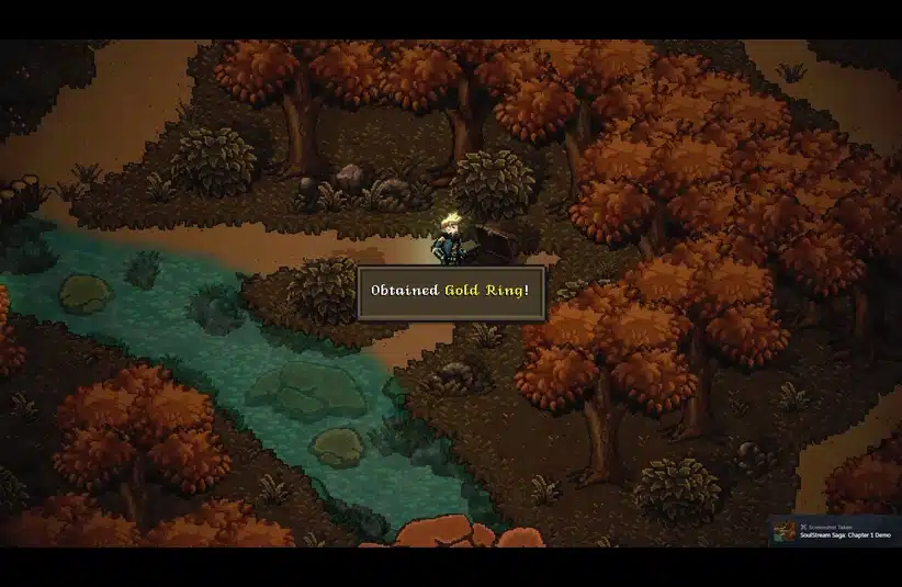 Pixel art scene in an autumnal forest features vibrant orange trees beside a winding turquoise river. A character stands by a treasure chest, with text: "Obtained Gold Ring!" The mood is adventurous.