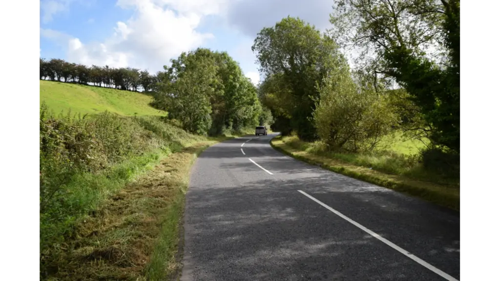 A quiet rural mystery road at Magnetic Hill in Cullion gently slopes through open countryside, creating the eerie optical illusion of cars rolling uphill.