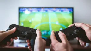 two people playing a football video Pocket Advance handheld game.