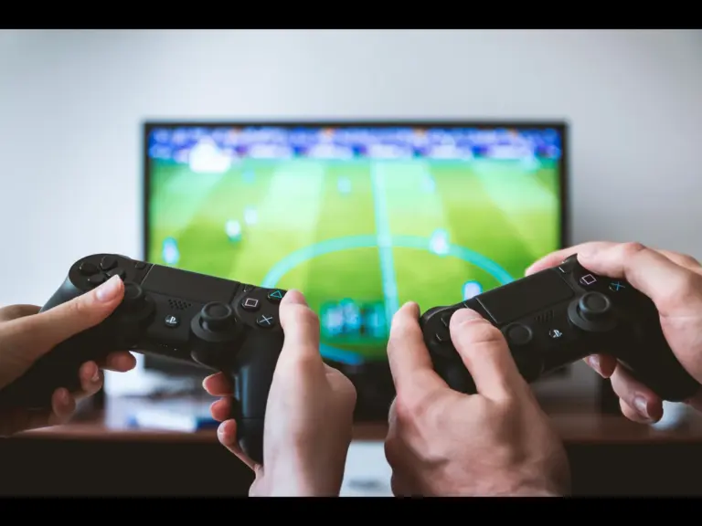two people playing a football video Pocket Advance handheld game.