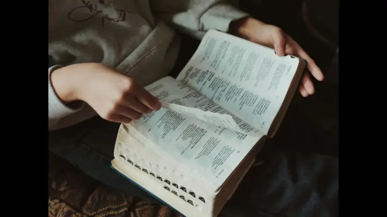 In daily devotional, someone is reading the Bible intently.