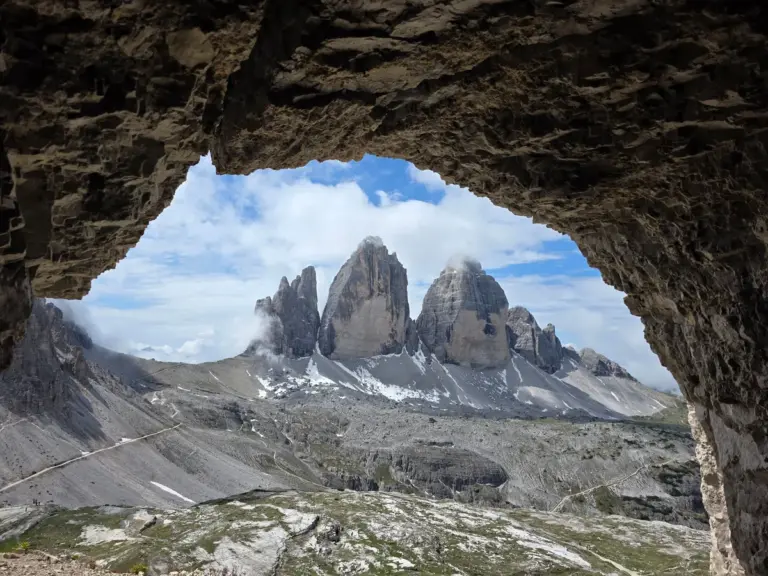In daily devotional, a mountainous region is shown from inside a cave. 