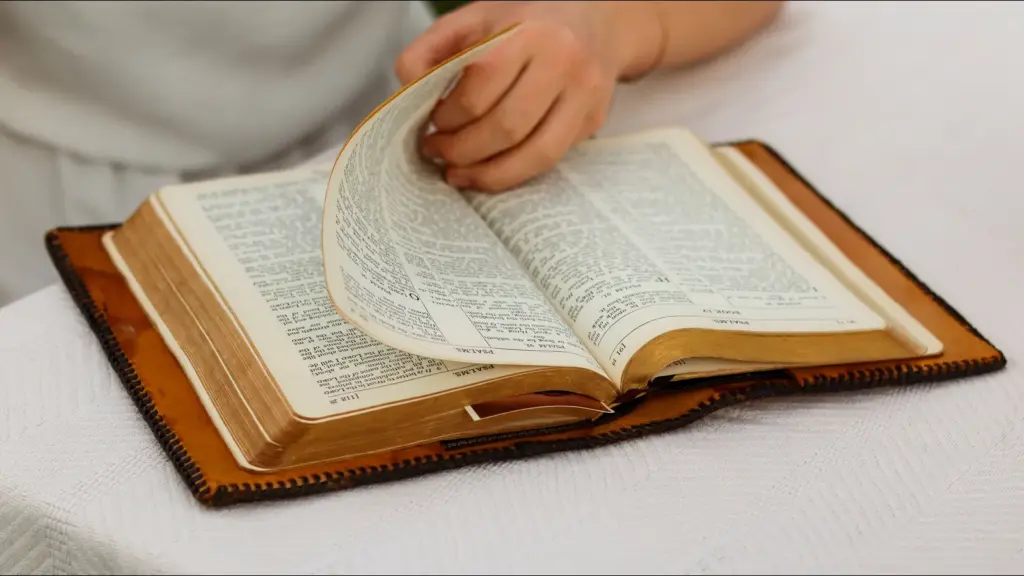 In daily devotional, a person reads the Bible as they turn the page.