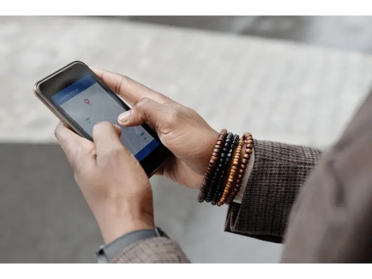 Hands using a smartphone, illustrating the Tsubomi shutdown report