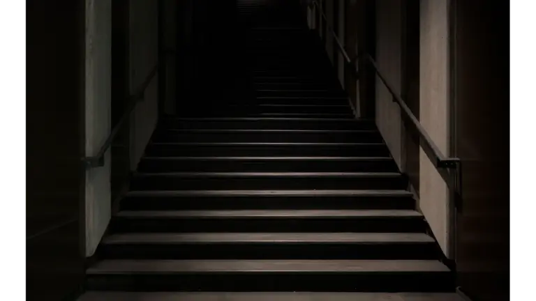 mystical stairs enveloped in darkness, featuring a subtle hint of set hauntings in the shadows.