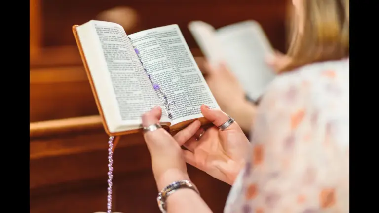 In today's daily devotional, a woman sits on a church pew and reads Scripture.