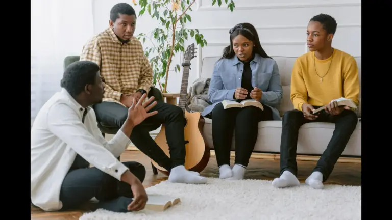 In Friday's daily devotional, a group of young adults is studying the Bible together in a home setting.