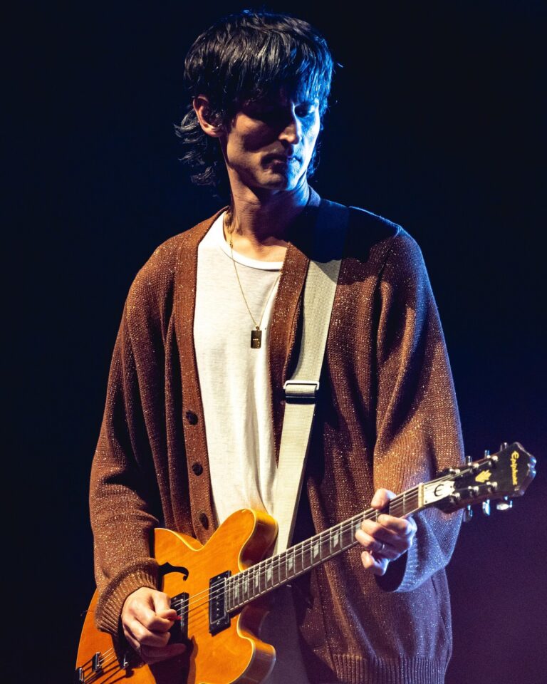 Nick Valensi plays guitar onstage with The Strokes during a New Year's Eve 2019 concert