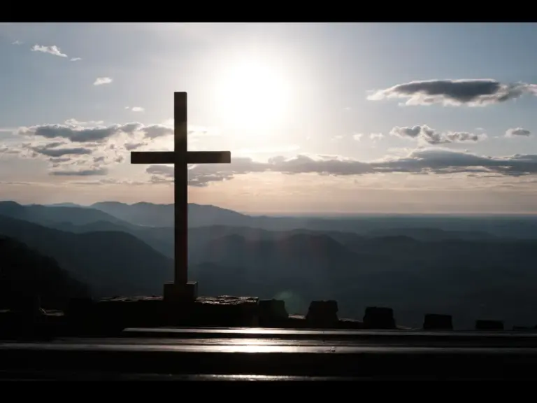 In Thursday's daily devotional, a cross is shown against a sunlit background as a symbol of God's grace. 