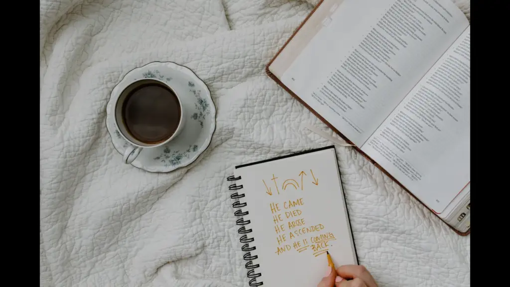 In Monday's daily devotional, a person studies the Bible with coffed and notepad close.