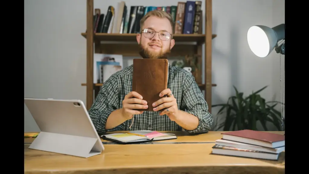 In Tuesday's daily devotional, a man holds up his Bible, as it looks like his study time.