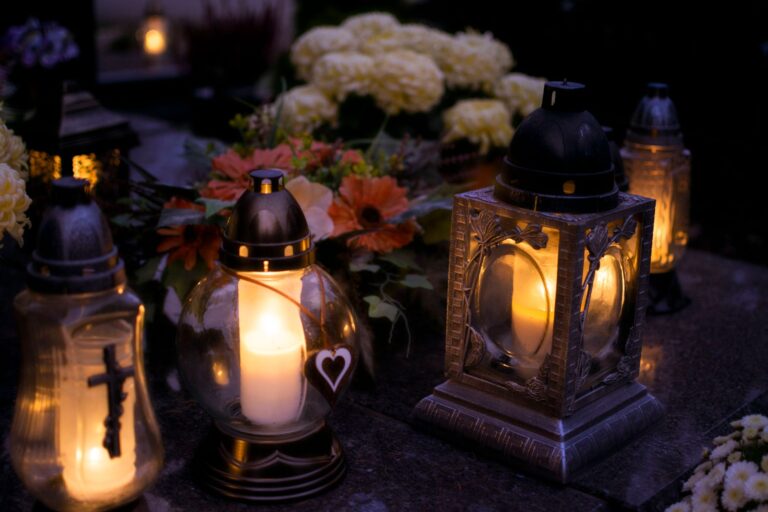 Cemetery lanterns glowing at night for All Saints' Day