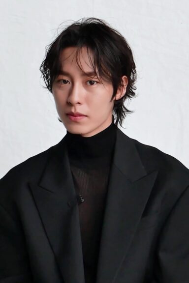 Dead-End Job Netflix star Lee Jae-wook, dressed in black, poses against a white background in a 2021 Marie Claire Korea interview